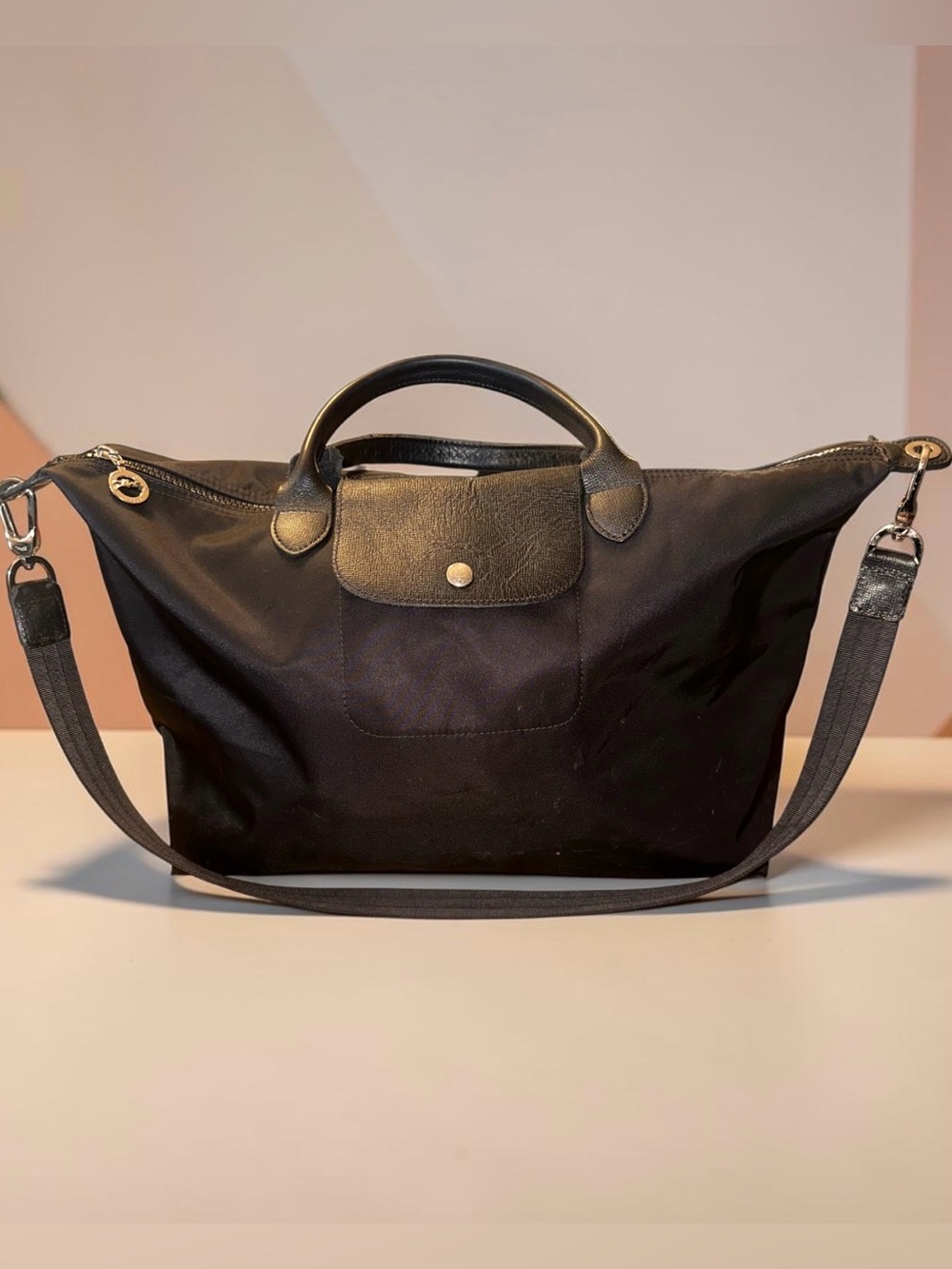 Longchamp Black Nylon travel tote with silver tone and leather accenta.